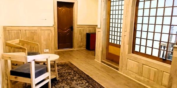 The interior of a cozy, well-lit room, part of the Fairlawns Homestay in Srinagar, which blends Kash