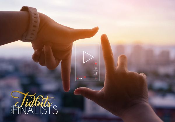 Hands framing a video play icon with cityscape background.
