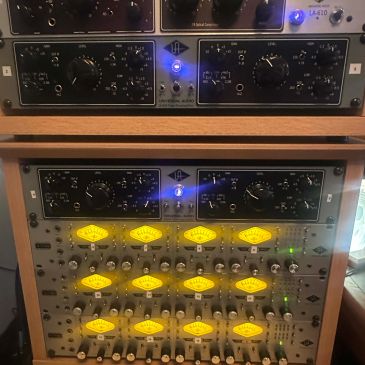 Audio equipment with illuminated yellow indicators.