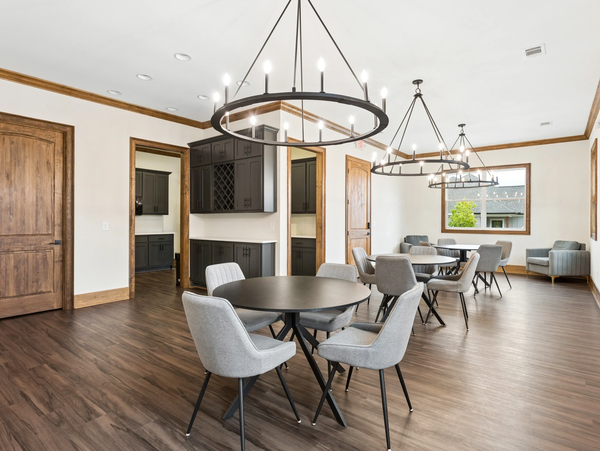 Modern dining area with round tables and gray chairs.