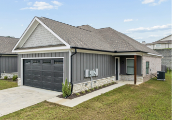 Modern single-story house with gray exterior and black garage door.