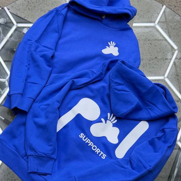 Two blue hoodies with white abstract designs and the word "SUPPORTS" printed on one.