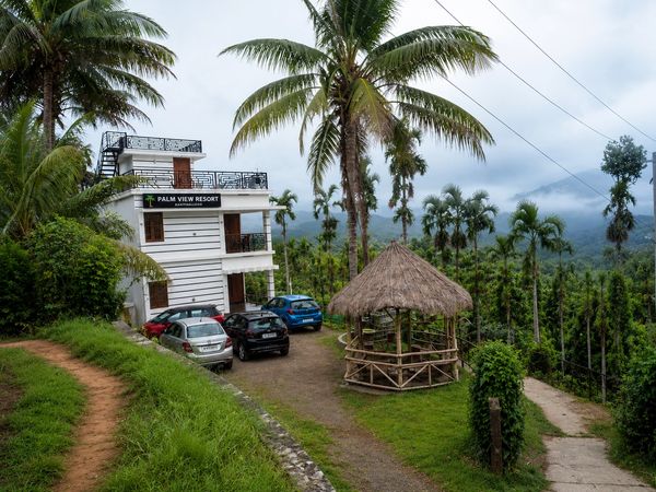 Palm View Resort amidst greenery and hills.