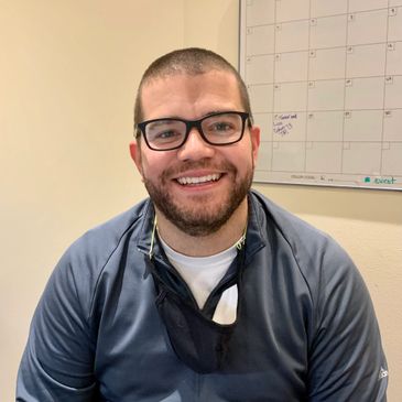 Dante Young, enrolment director, sitting in an office, smiling