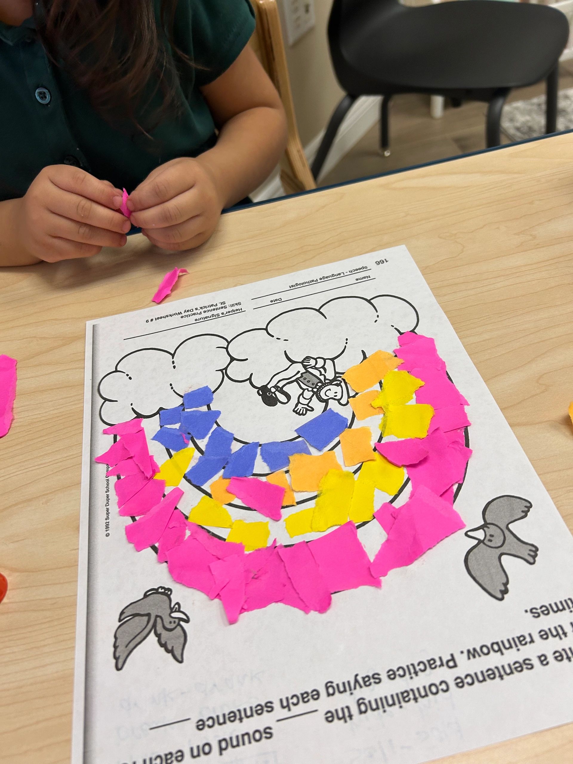 Child completing a colorful learning activity