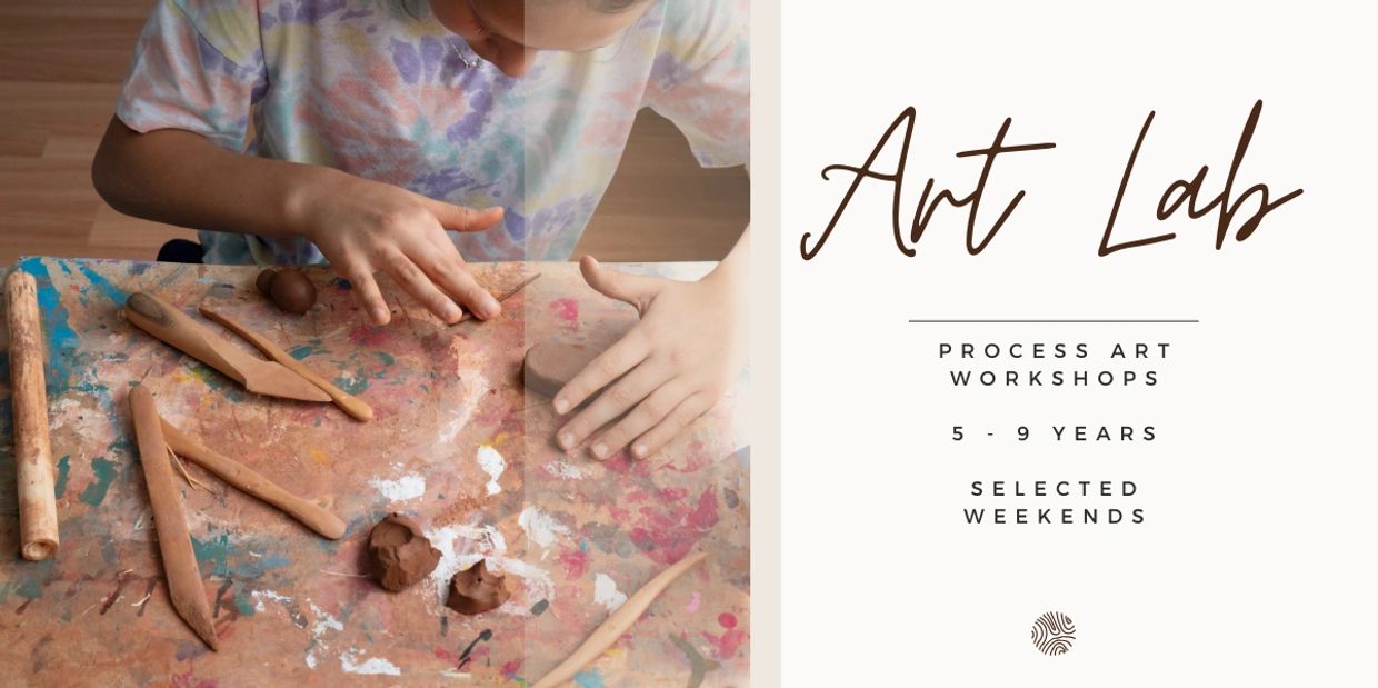 Child working with clay in an art lab workshop.