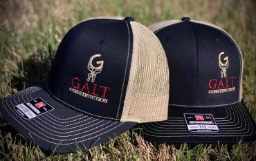 Two black and beige mesh caps with construction logos.