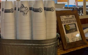 Stacked branded cups with a reserved VIP sign.