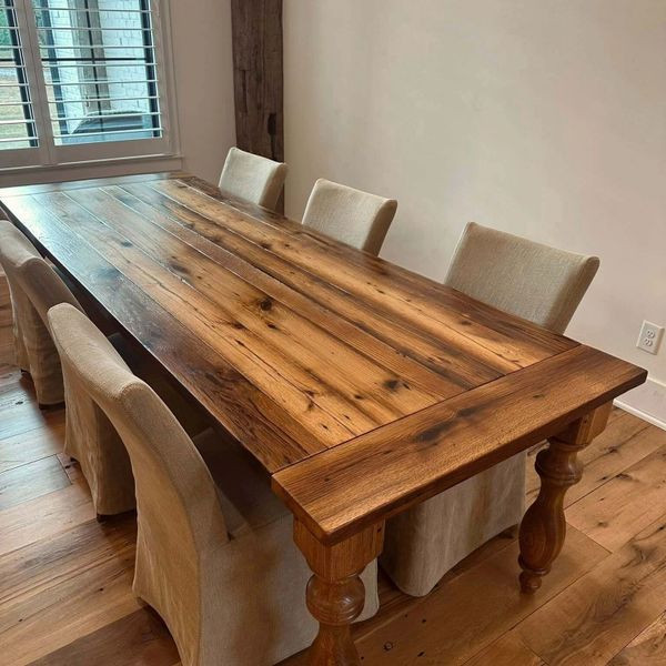 Reclaimed lumber dining table with breadboard ends and custom turned legs