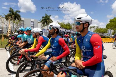 Cyclists lined up and ready to race outdoors.