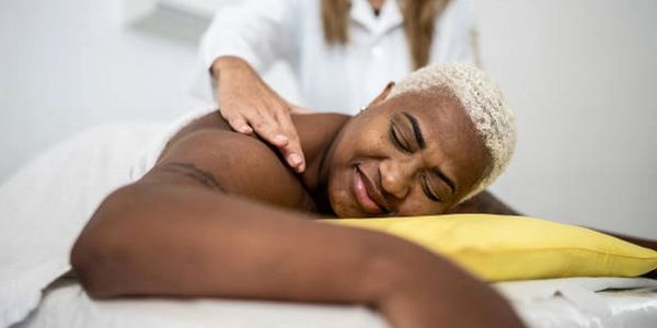 closeup shot of a woman relaxing while getting a massage 