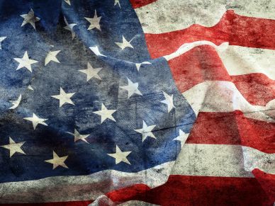 Worn and weathered American flag with visible stars and stripes.