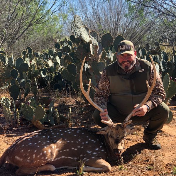 Image of hunter and harvested axis buck in south Texas near Hideaway in Hindes. 