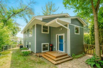 Cute cottage with blue front door and wooden steps