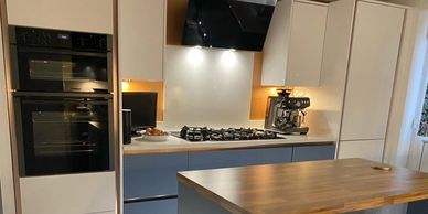 Blue and white handleless luxury kitchen design for clients in South Wales with a modern island look