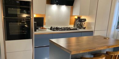 Blue and white handleless luxury kitchen design for clients in South Wales with a modern island look