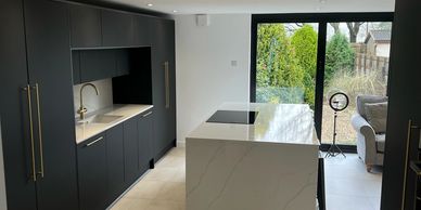 A black modern kitchen with a quartz worktop is on trend in the design industry. A high end look 