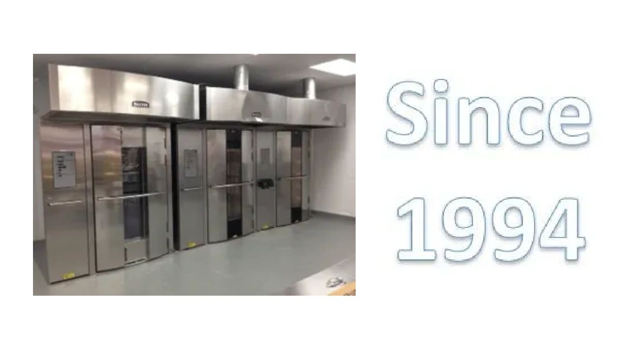 Long row of modern commercial bakery ovens.
