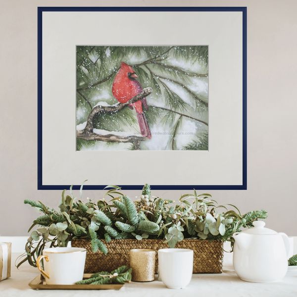 Red cardinal watercolor by Kathryn Taylor, perched on a snowy pine branch, a peaceful winter scene.