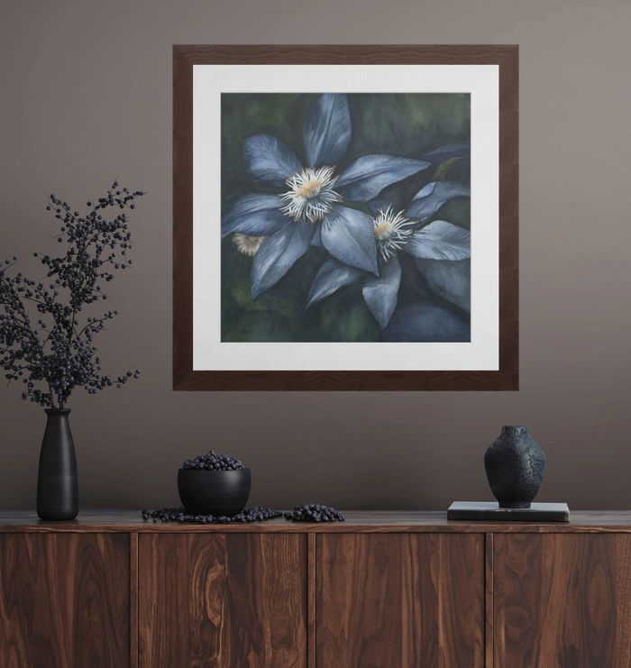 Three adults focused on drawing portraits on easels in an art class.