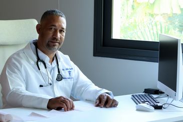 Doctor sitting at desk in office.