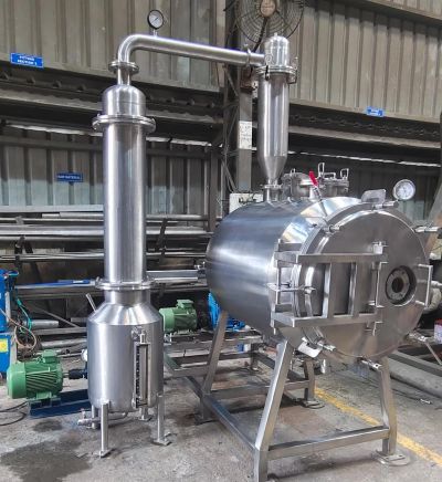Industrial stainless steel distillation or extraction equipment.