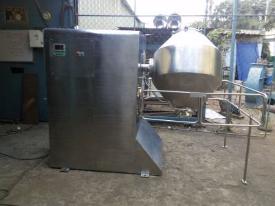 Industrial stainless steel mixing machine with a conical tank.