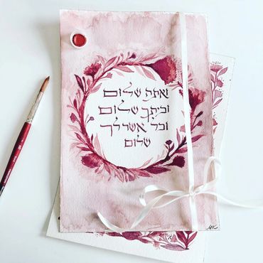 watercolor painting with Hebrew calligraphy and paint brush