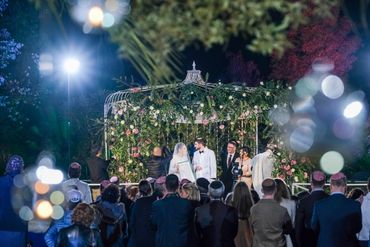 chuppa ceremony with couple holding ketubah