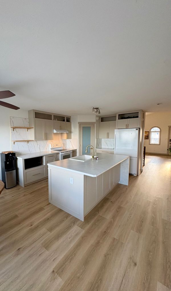 Bright modern kitchen with white cabinets and a large island.