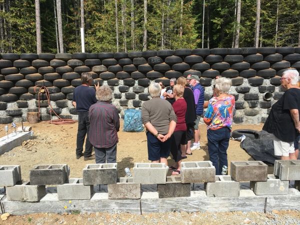 Group of people looking at the rear tire wall during our second annual open house in 2019.  