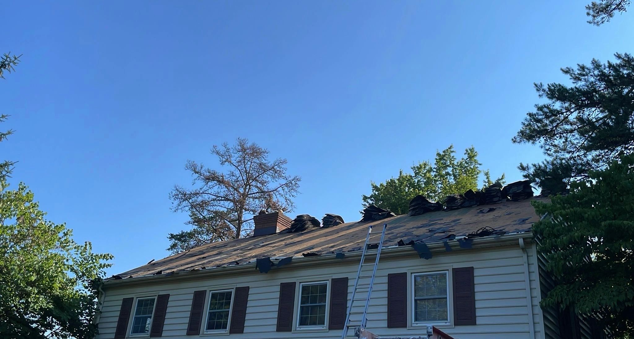 House roof under repair on a clear day.