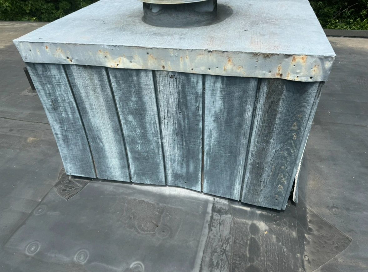 Weathered chimney structure on a rooftop.