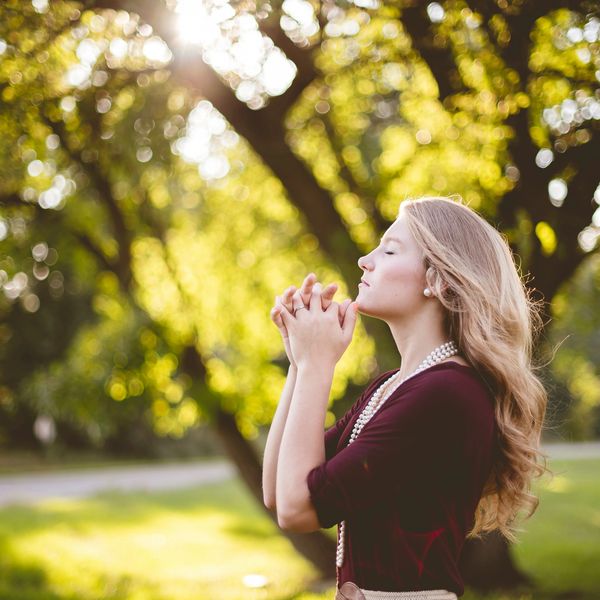 An introvert Christian woman praying.

Photo by <a href="https://unsplash.com/@benwhitephotography