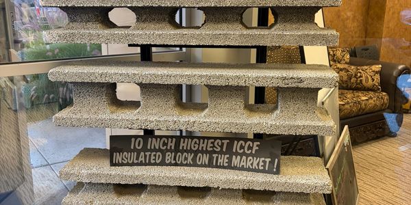 Stack of insulated blocks with promotional sign.