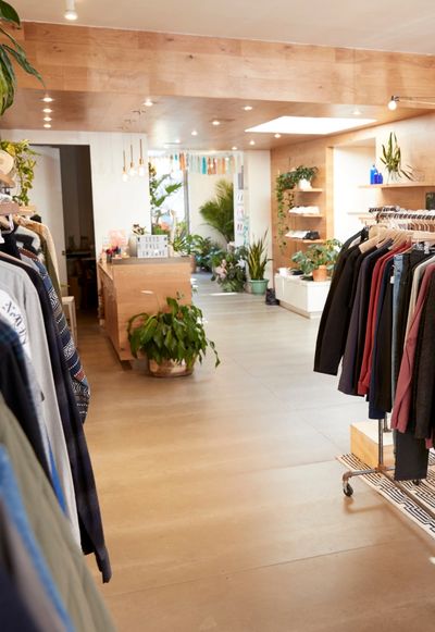 An image of a retail shop with wooden shelving.