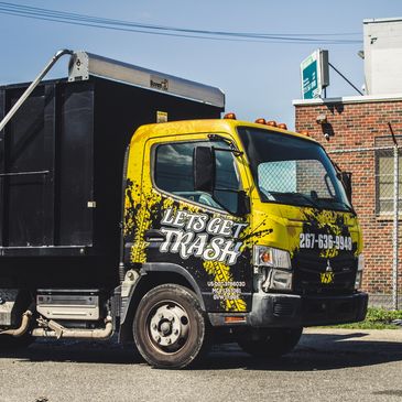 black and yellow dump truck. used for cleanouts, recycling, donations and trash removal.