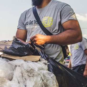 employee recycling bags of plastic