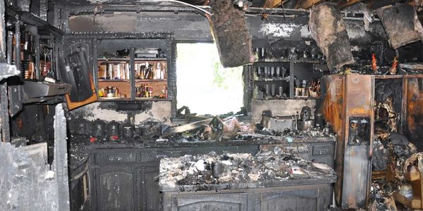 Fire damage with smoke and soot  in residential kitchen due to an accidental grease fire. 