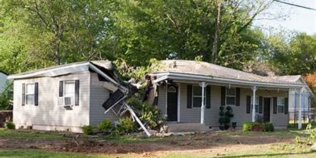 Roof damage by a severe storm, highlighting 24/7 storm damage emergency services in West Kentucky.