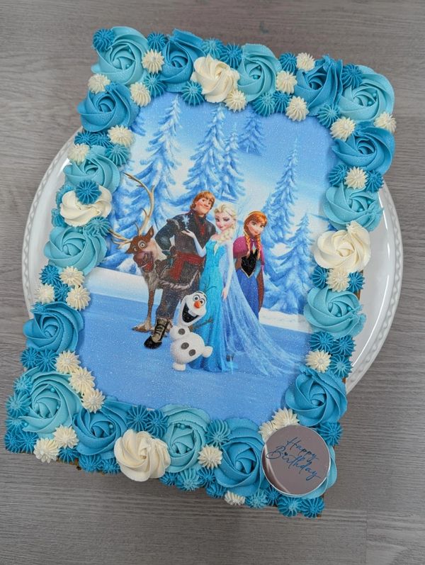 Frozen-themed birthday cake with blue and white frosting.