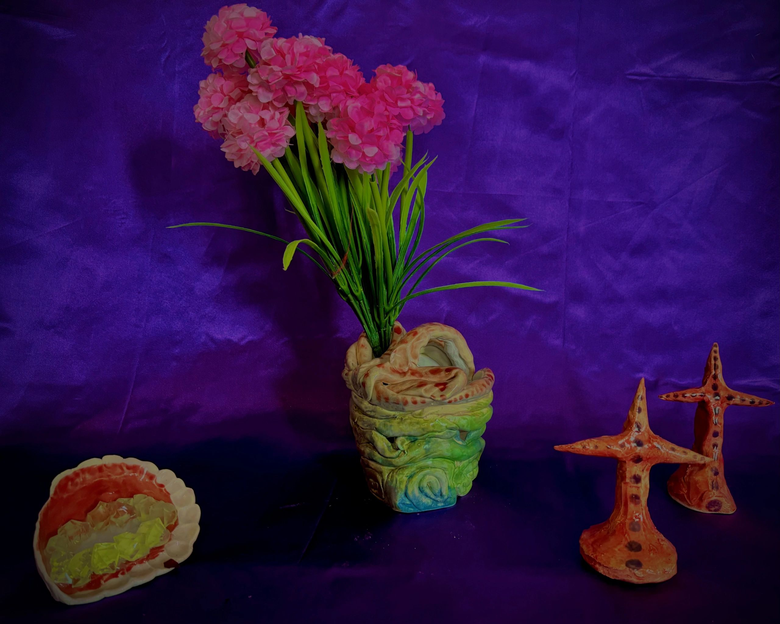 Colorful ceramics with pink flowers and starfish decorations.