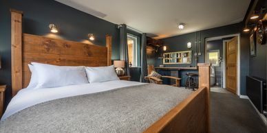 Cozy bedroom with a wooden bed frame and rustic decor.