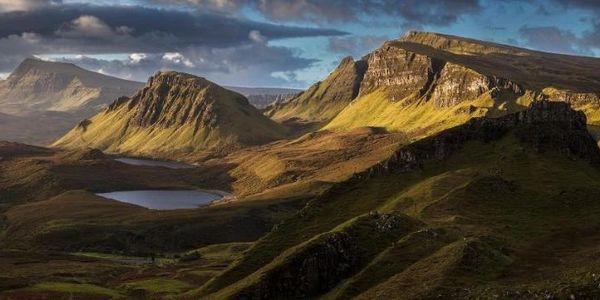 Sunlit rugged Quiraing and lochs under a partly cloudy sky.
Isle of Skye Luxury Accommodation