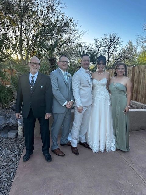 group photo with officiant and bride and groom