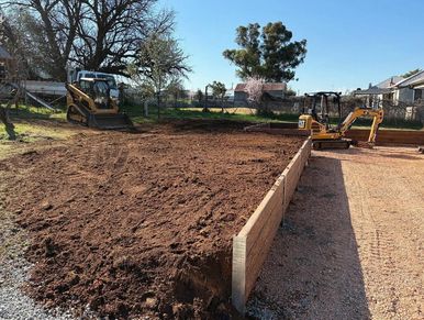 Construction site with soil and excavators preparing the ground.