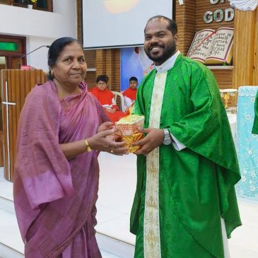 Woman presenting a gift to a priest in church.