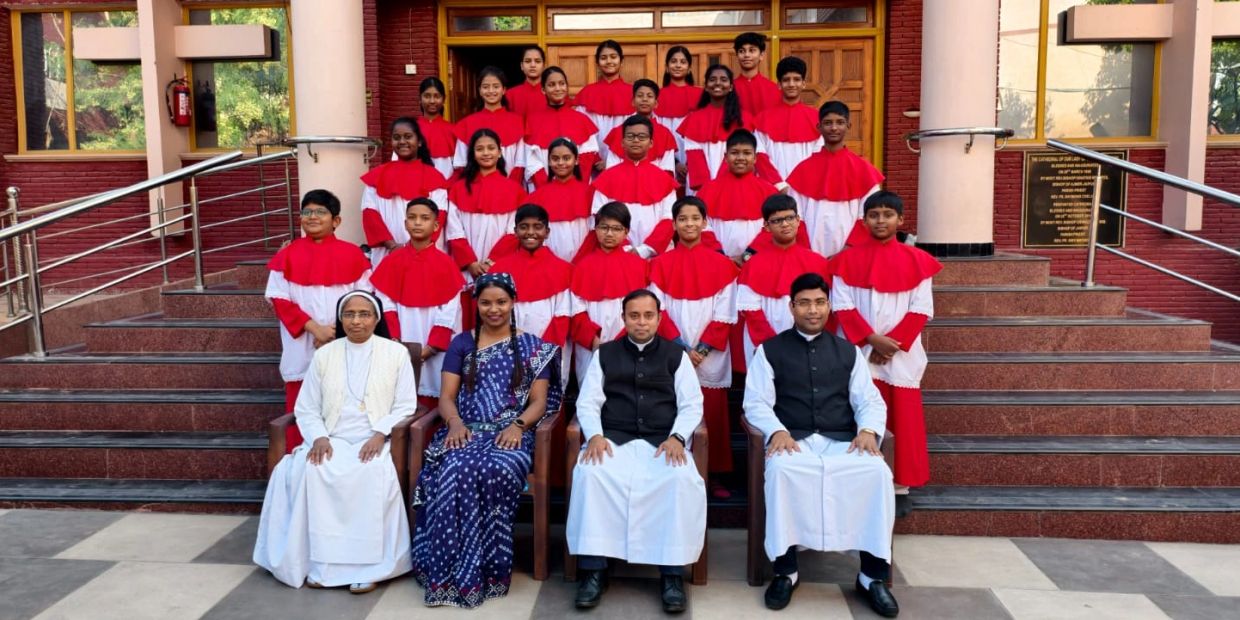 Large choir group photo with clergy and a woman in traditional dress.