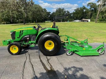 <img src="tractor.jpg" alt="green tractor attached to large mower">