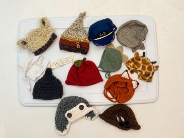 Collection of handmade knit hats in various styles and colors.